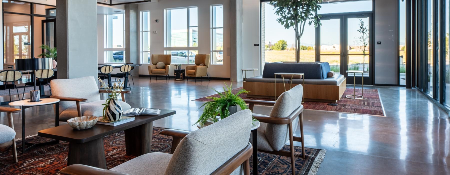 a room with a large glass wall and a large table with chairs